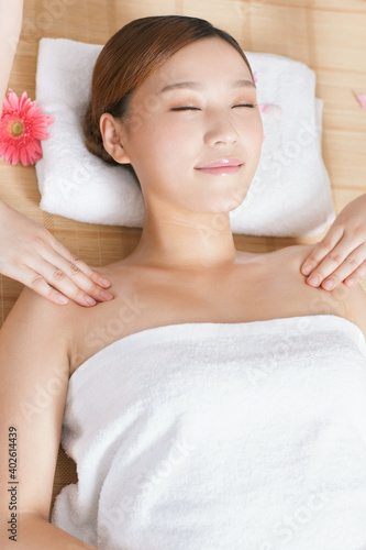A young women lying in bed enjoying massage