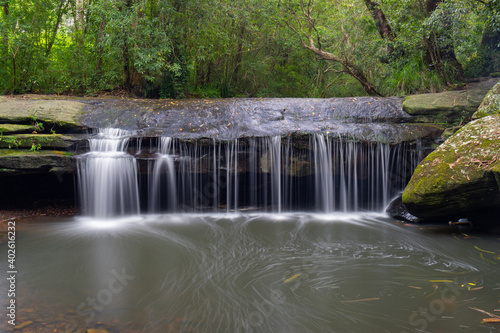 Terry s creek waterfall with green foliage around.