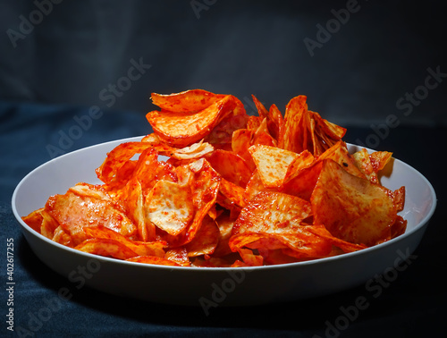 spicy cassava chips isolated on black background