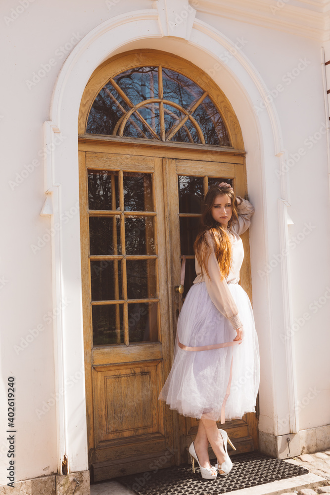 Girl in a white tutu in a city garden
