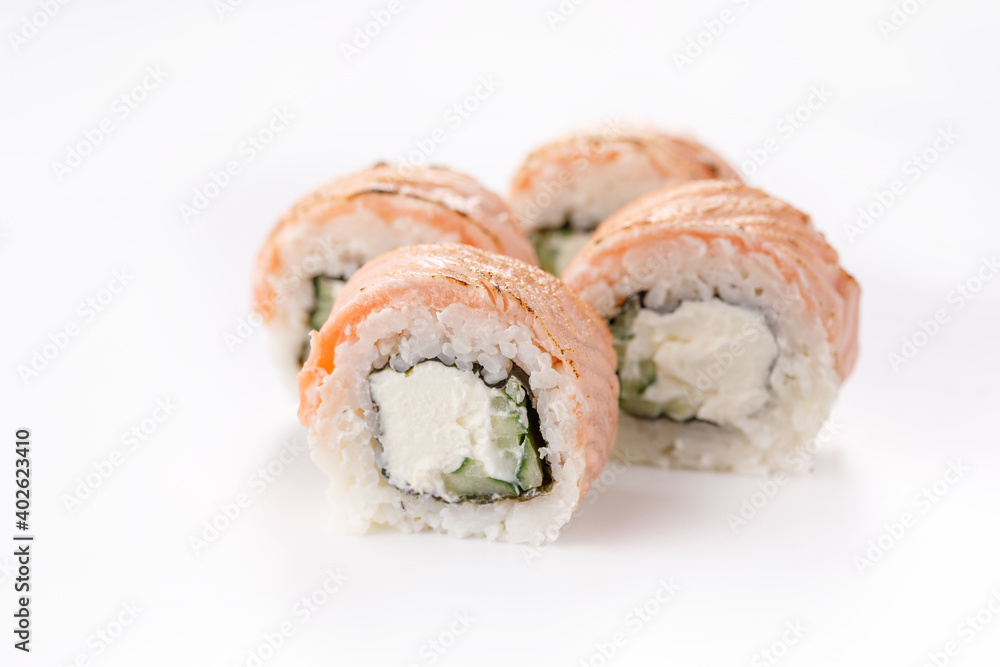 Baked Philadelphia sushi rolls on a white background. Isolated. Restaurant concept. Close-up. Baked Philadelphia sushi rolls on a white background. Isolated. Restaurant concept. Close-up.