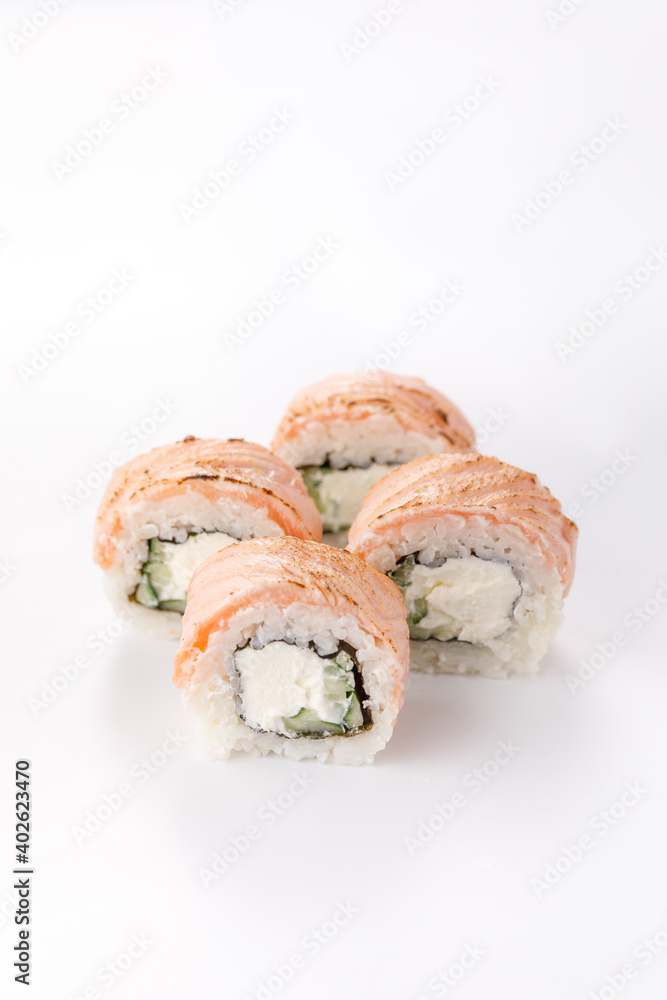 Baked Philadelphia sushi rolls on a white background. Isolated. Restaurant concept. Close-up. Baked Philadelphia sushi rolls on a white background. Isolated. Restaurant concept. Close-up.