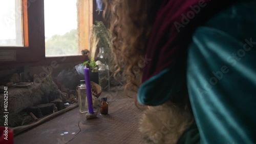 woman blowing out a candle on a misterious environment photo