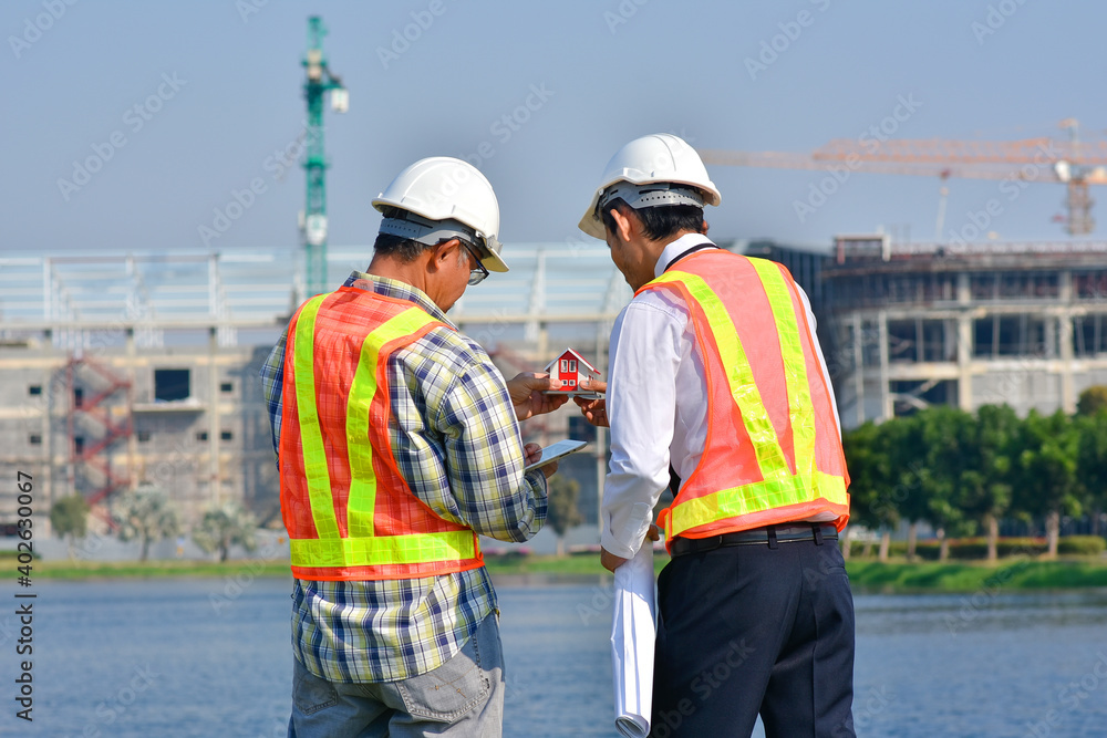 Engineer hold a blueprint for the construction factory in an industrial area. Engineer hold a blueprint for the construction factory in an industrial area.