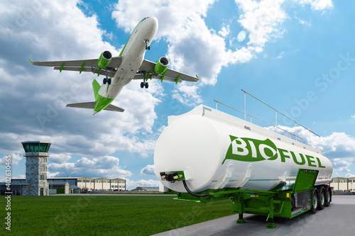 Airplane and biofuel tank trailer on the background of airport. New energy sources	 photo
