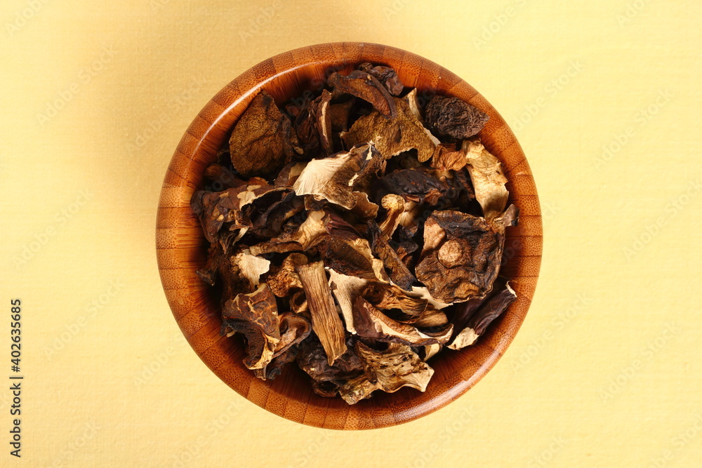 Dried mushrooms in wooden bowl. Boletus badius. Dried mushrooms in wooden bowl. Boletus badius.