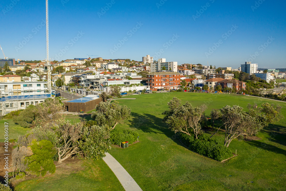 Low Aerial drone view of Mackenzies Point and iconic Bondi Beach in Sydney, Australia during summer on a sunny morning  