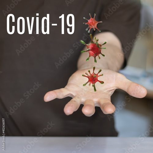 3d- image of stylized covid viruses hanging over a human palm