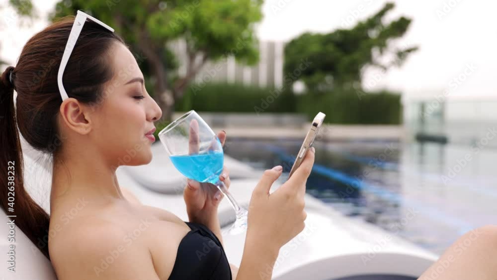Asian young woman relaxing in swimming pool at luxury hotel spa enjoying beautiful sunset . Close up Female Enjoying Summer Travel .vacation woman in bikini . Asian young woman relaxing in swimming pool at luxury hotel spa enjoying beautiful sunset . Close up Female Enjoying Summer Travel .vacation woman in bikini .