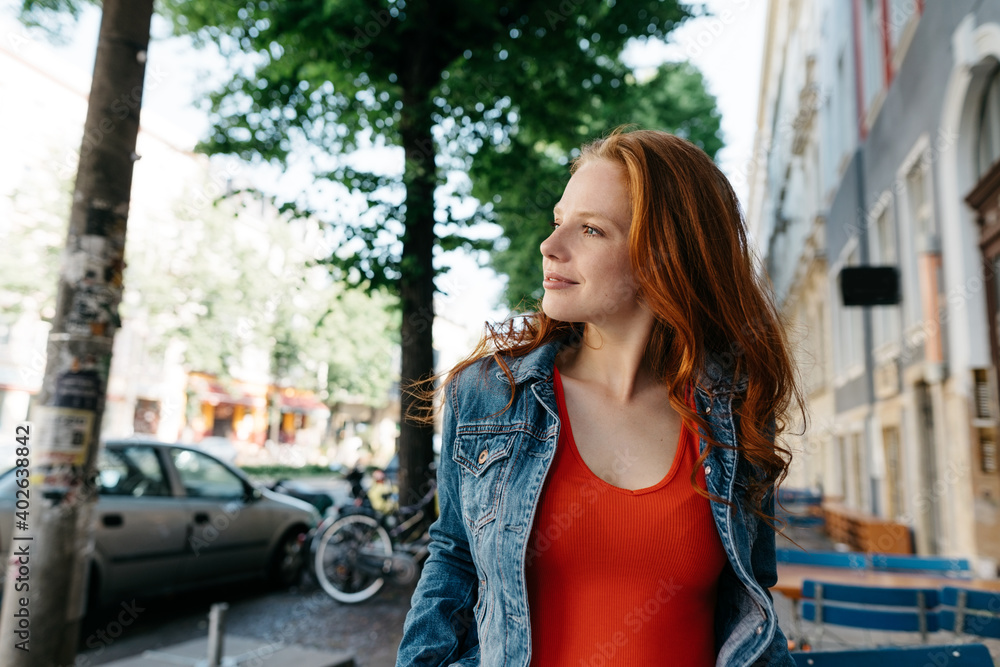 Fototapeta premium Thoughtful attractive young redhead woman