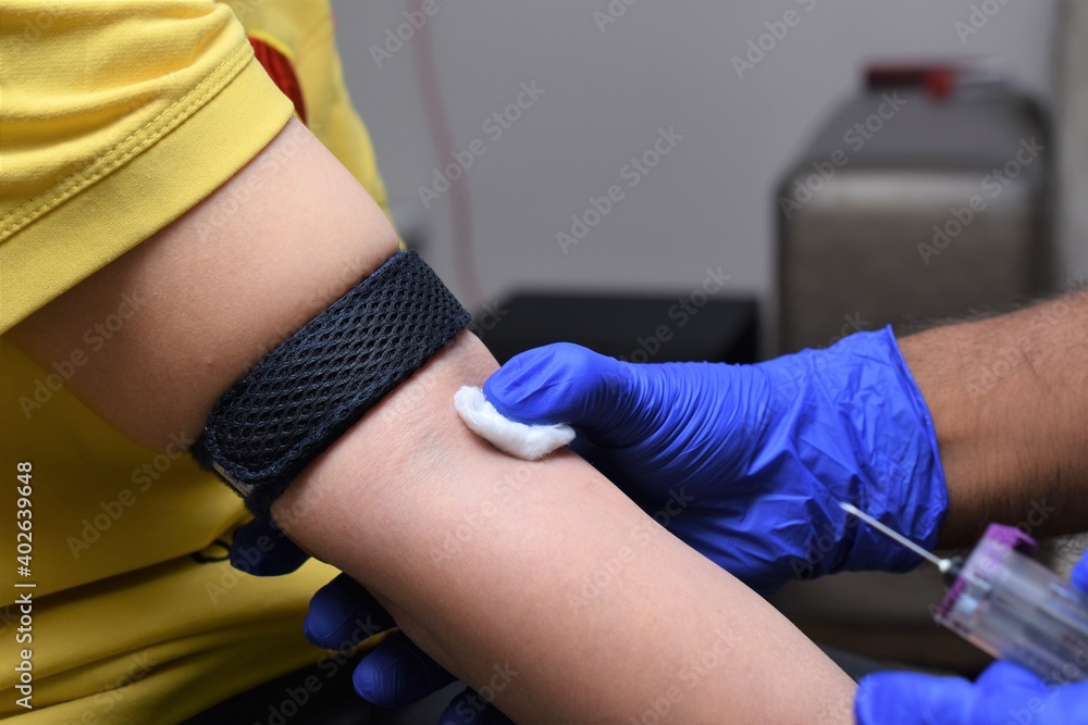 doctor pressing cotton with thumb finger after giving injection on the arm pit of the patient doctor pressing cotton with thumb finger after giving injection on the arm pit of the patient