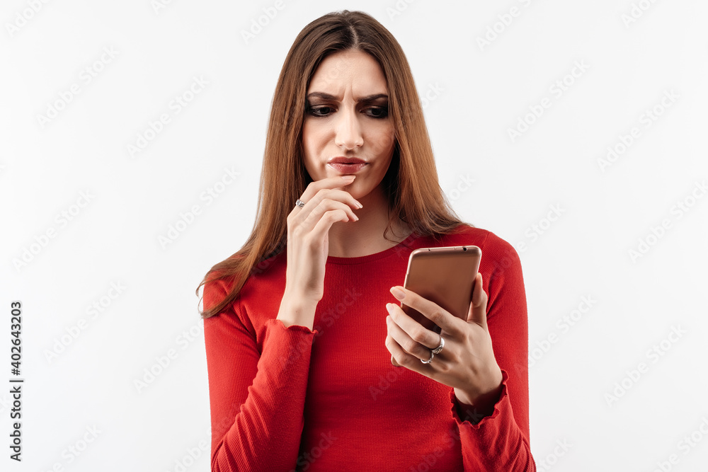 Young woman with long chestnut hair using mobile phone. Studio shot, white background, isolated Young woman with long chestnut hair using mobile phone. Studio shot, white background, isolated