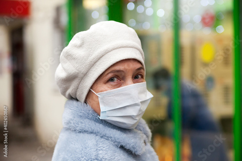 Senior woman wearing face mask  near   supermarket © DariaTrofimova