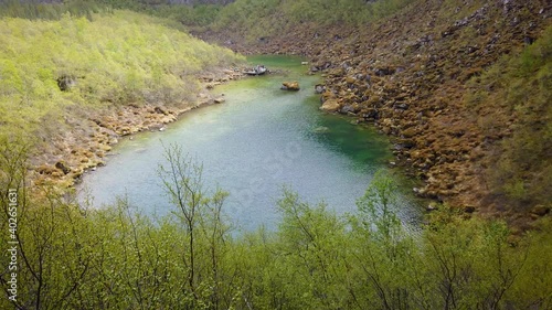 Asbyrgi Glacial Canyon in Northern Iceland. Asbyrgisskogur forest and Botnstjorn lake are surrounded by the vertical wall mountain wall. photo