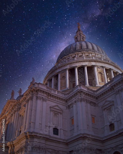 St Paul's cathedral dome illuminated by starry night sky, London UK