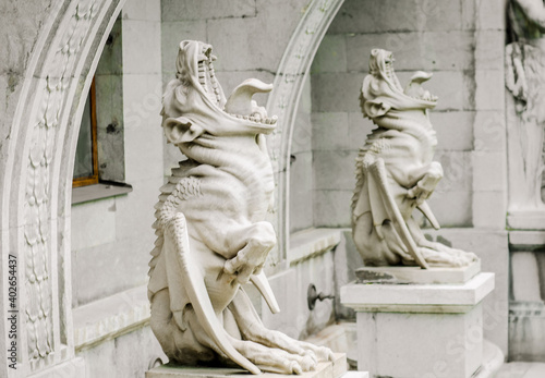 Photography Scary gargoyles with open mouths near  walls of  house