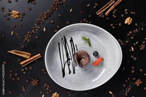 slice of cacke in beautiful plate on the table decorated with coffee beans photo