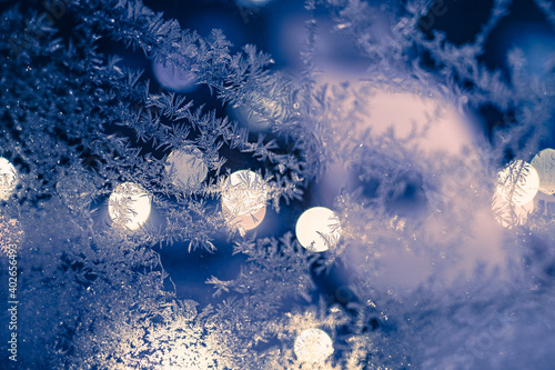 A frozen Window with ice crystals in a silent winter night