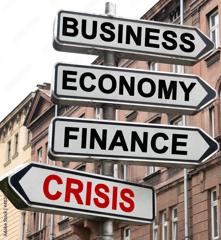 The road indicator on the arrows of which is written - business, economics, finance and CRISIS The road indicator on the arrows of which is written - business, economics, finance and CRISIS