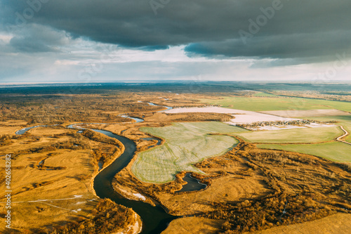 Aerial View Of Dry Grass And Partly Frozen River Landscape In Late Autumn Day. High Attitude View. Marsh Bog. Drone View. Bird s Eye View