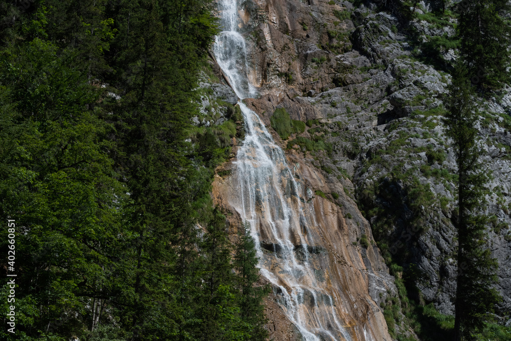 wonderful steep waterfall over rocks in the mountains