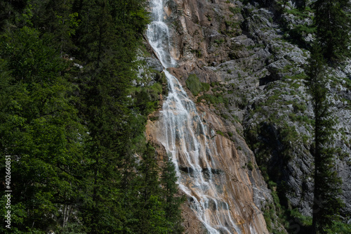 wonderful steep waterfall over rocks in the mountains