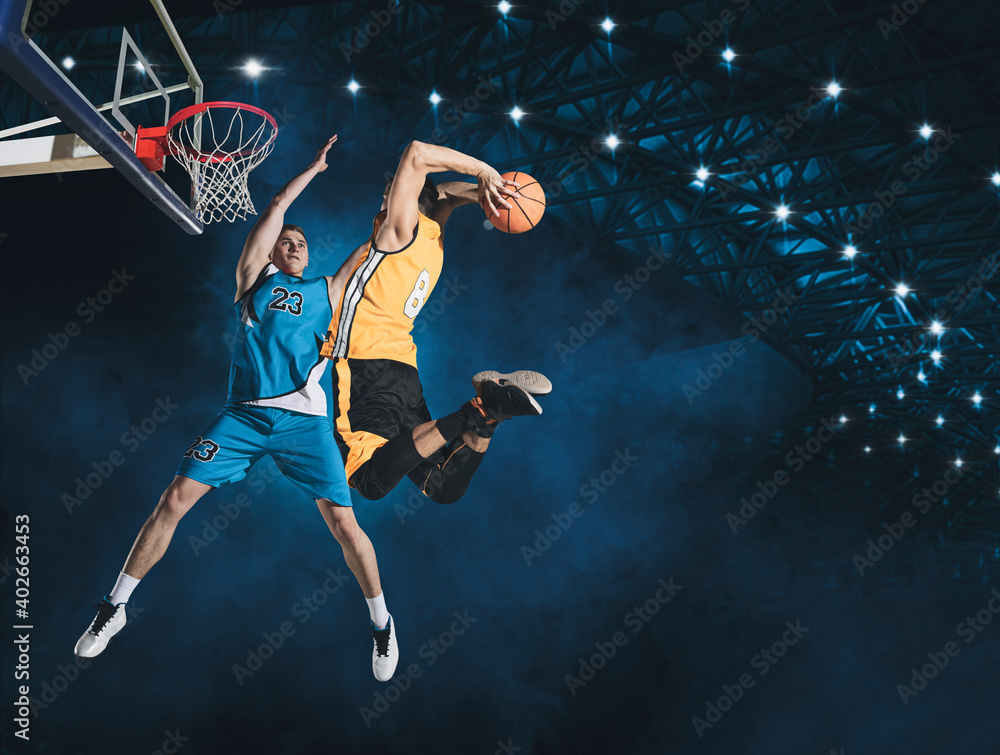Naklejka premium Two basketball players in arena. Blocked shot