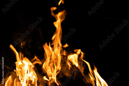 Fire flames on a black background. Abstract fiery texture. Realistic fire flames burn movement frame. Texture for Design. The texture of fire. Fire flames background. Blazing campfire. Sensitive focus