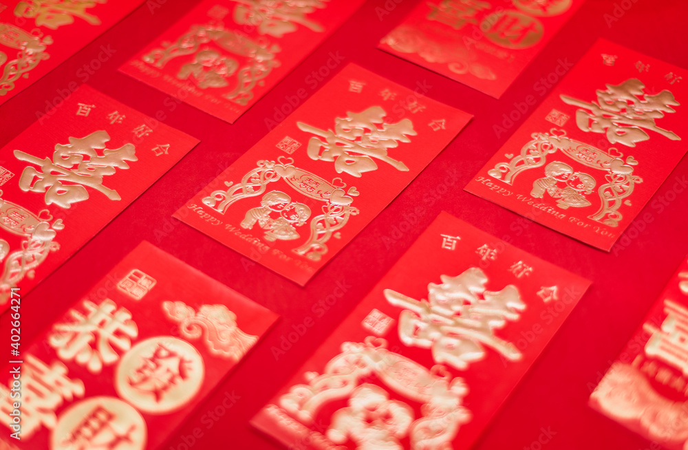 Chinese wedding gift red packets neatly arranged on red background Chinese wedding gift red packets neatly arranged on red background