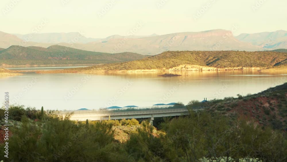 Beautiful sunset at Theodor Roosevelt Lake, Panorama with car passing, crossing bridge. AZ, USA. Panorama right to left. Beautiful sunset at Theodor Roosevelt Lake, Panorama with car passing, crossing bridge. AZ, USA. Panorama right to left.