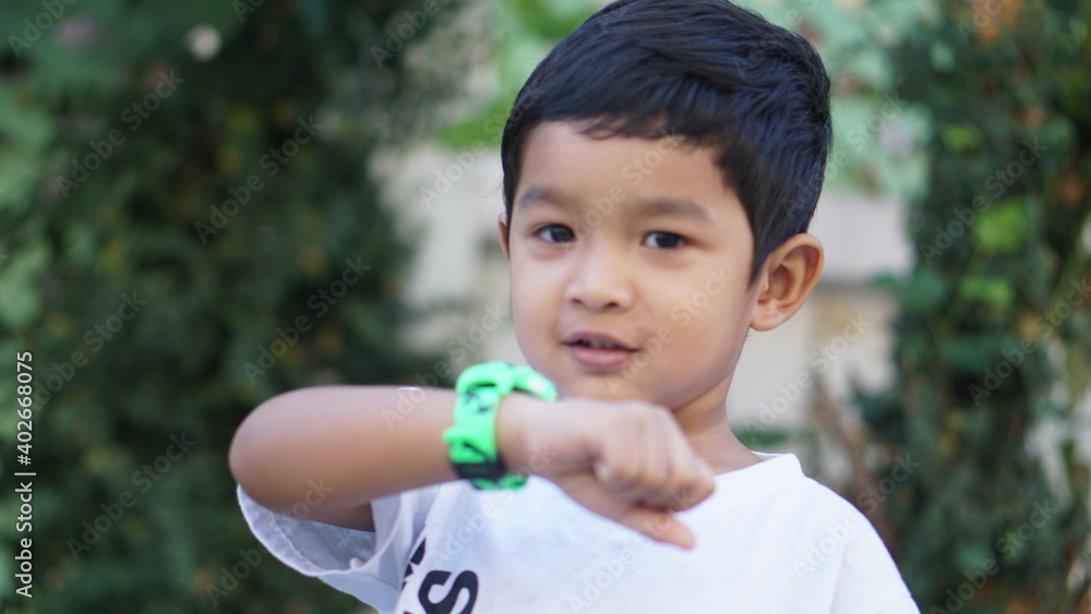 Wearable kids baby smart watch calls mom and location tracking with touch screen and voice service green multicolored electronic gadget with rubber wristband for children. Close up boy with copy space Wearable kids baby smart watch calls mom and location tracking with touch screen and voice service green multicolored electronic gadget with rubber wristband for children. Close up boy with copy space