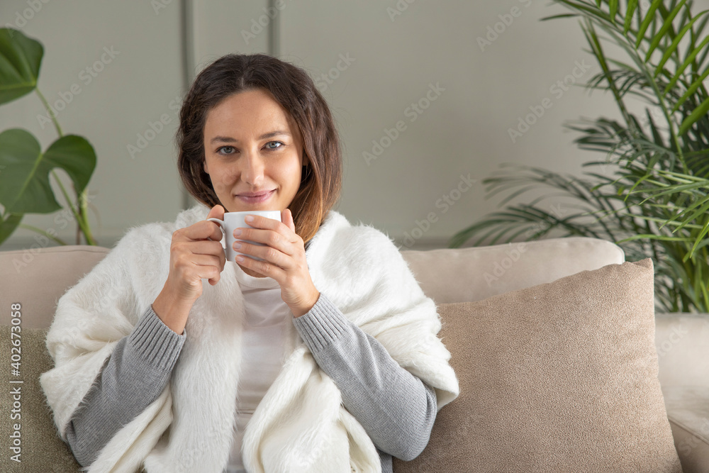 Serene young woman enjoying hot coffee at home Serene young woman enjoying hot coffee at home