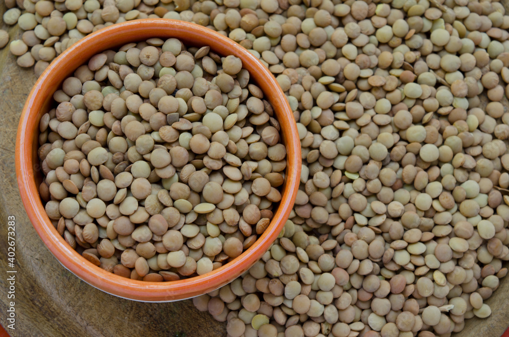 lentils background, on a wooden plate, organic legumes lentils background, on a wooden plate, organic legumes