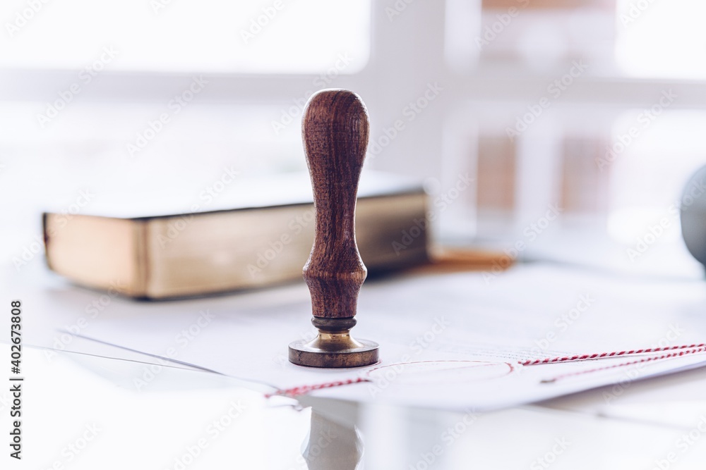 Notary stamp on a table in a notary's office. Notarized document.