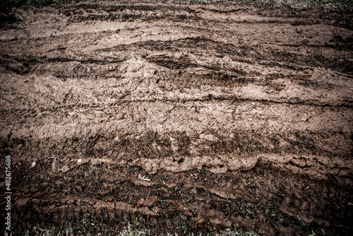 Tyre track on dirt sand or mud, Picture in retro or grunge tone. Car drive on sand. off road track. Track on grass field. Track in farm.