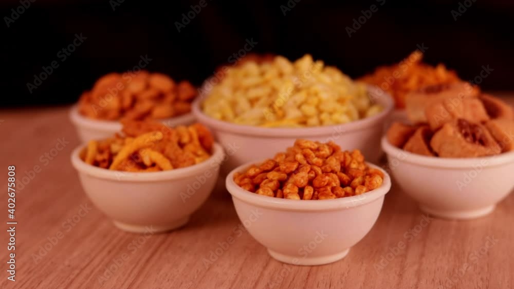 black background with Namkeen or Assorted Salty Snack on wooden spoon in white bowl close up, indian sneak,Namkeen in a bowl,Namkeen or Assorted Salty Snack on wooden spoon in white bowl,Namkeen, black background with Namkeen or Assorted Salty Snack on wooden spoon in white bowl close up, indian sneak,Namkeen in a bowl,Namkeen or Assorted Salty Snack on wooden spoon in white bowl,Namkeen,