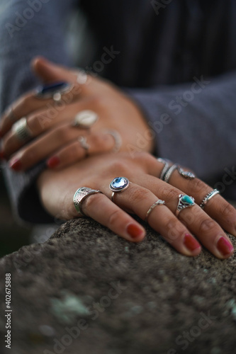 young woman hand posing with many rings