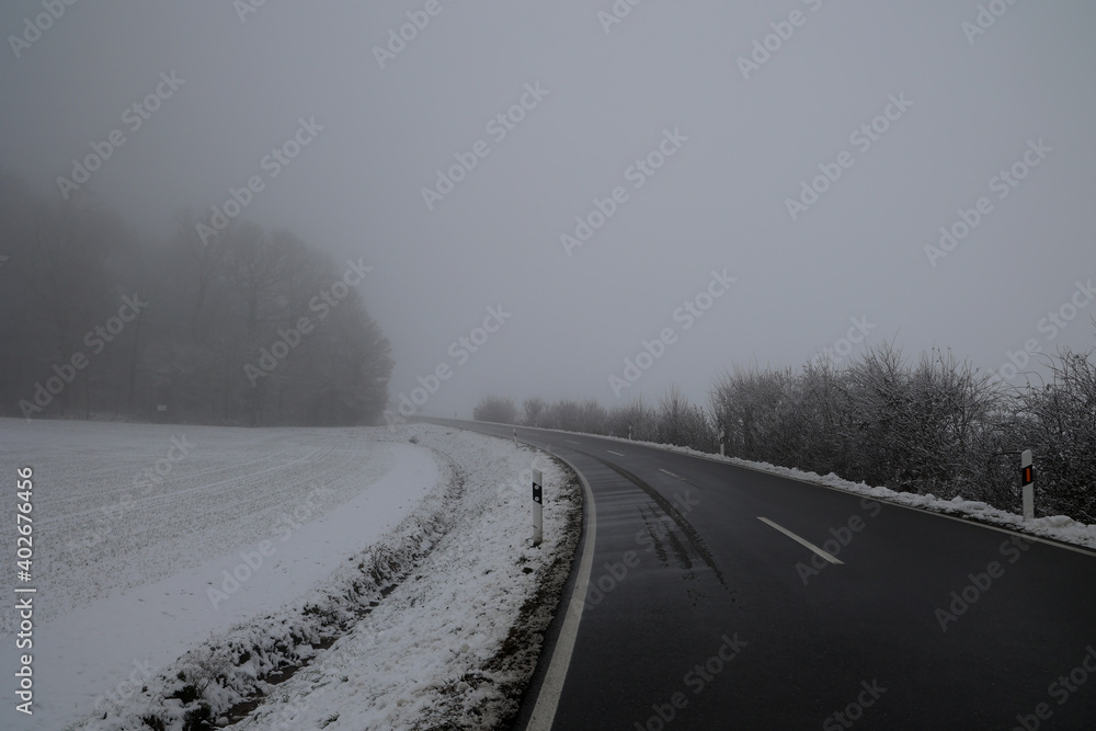 Dangerous stretch of road on a foggy winter morning Dangerous stretch of road on a foggy winter morning