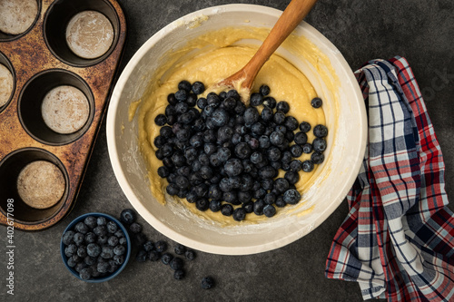 Photography Blueberries being added to the batter to make blueberry muffins