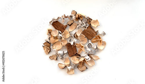 Spa background. Flavored potpourri flowers on white background, space for text. Dried potpourri leaves laid in the center of the screen top view. Beige sail champagne colour concept 