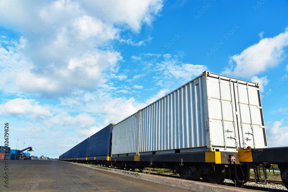 Cargo train platform with freight train Containers on the train on crane loading in port background. Cargo train platform with freight train Containers on the train on crane loading in port background.