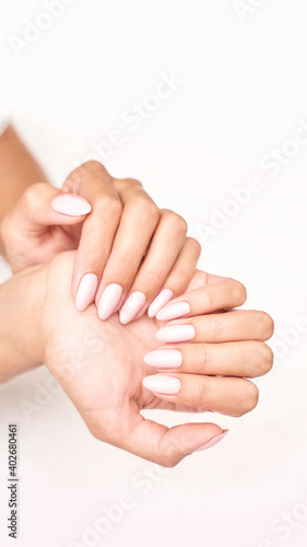 Classic pink wedding nail manicure on white backdrop. Spa treatment concept. Towel background. Natural hygiene. Health care. Beauty spa salon. Salon procedure Woman body care.