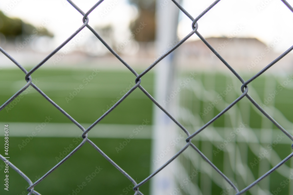 Empty soccer field closed with a metal fence Empty soccer field closed with a metal fence