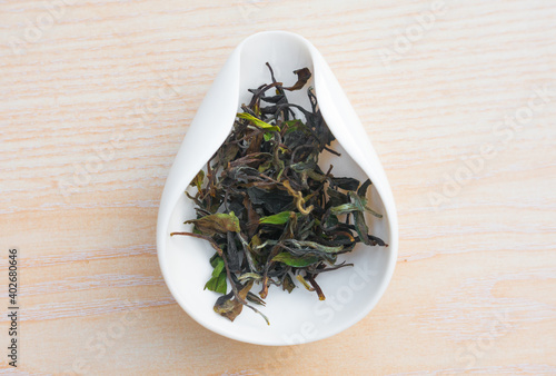 Aged white tea leaves in a porcelain object, ready to be brewed Gong Fu Cha.