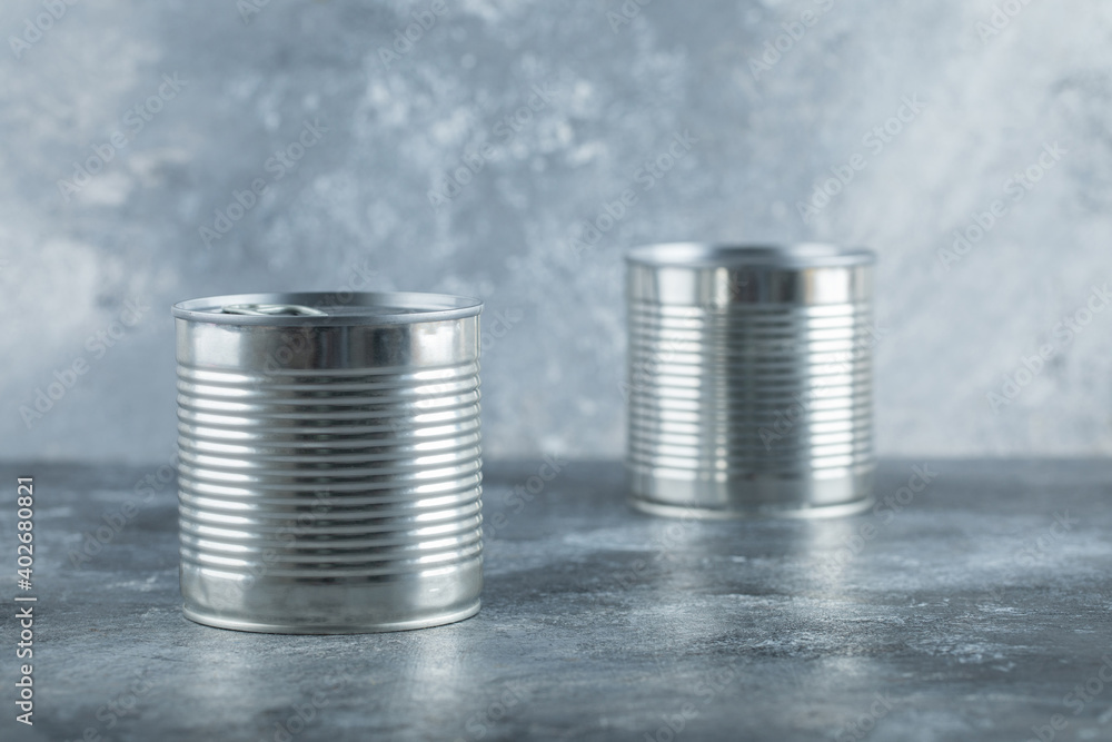 Two metallic cans on a marble background Two metallic cans on a marble background