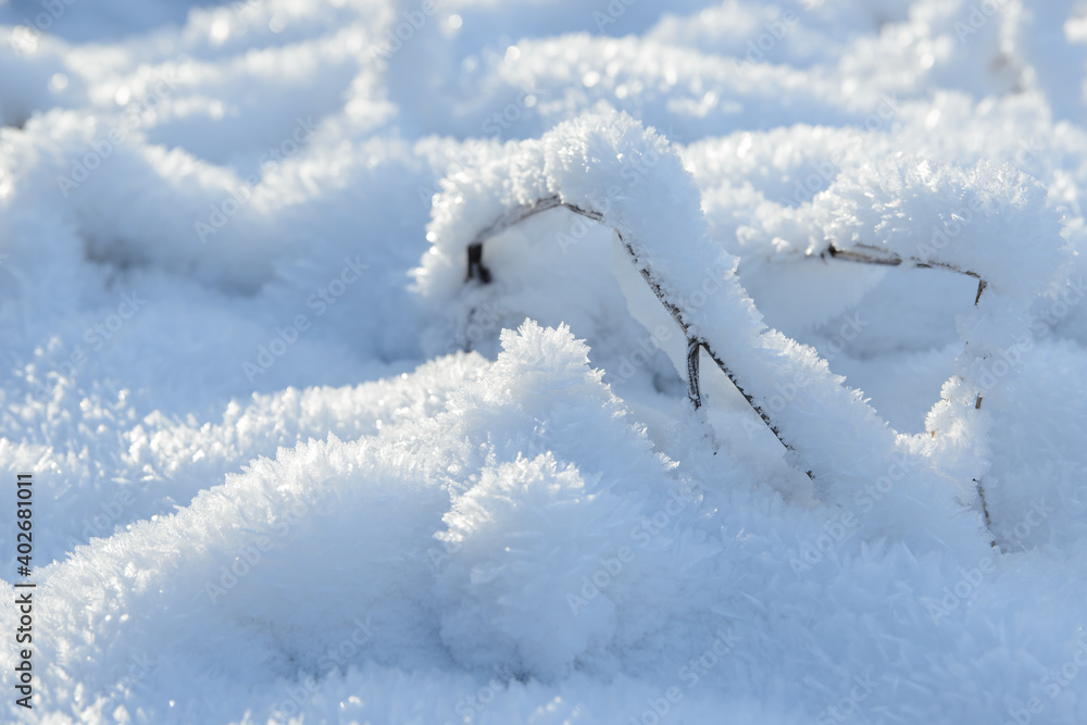 Hoarfrost background texture. Fresh ice and snow winter backdrop with snowflakes and mounds. Seasonal wallpaper. Frozen water geometrical shapes and figures. Cold weather atmospheric precipitation.