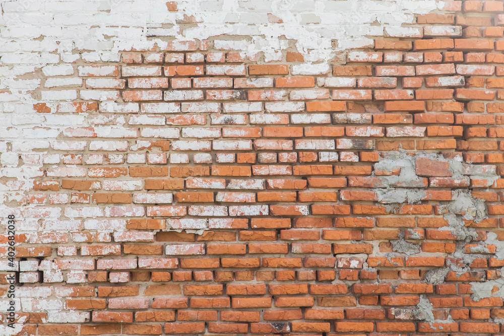 background of Old rough brick wall with stucco residues background of Old rough brick wall with stucco residues