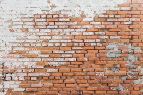 background of Old rough brick wall with stucco residues