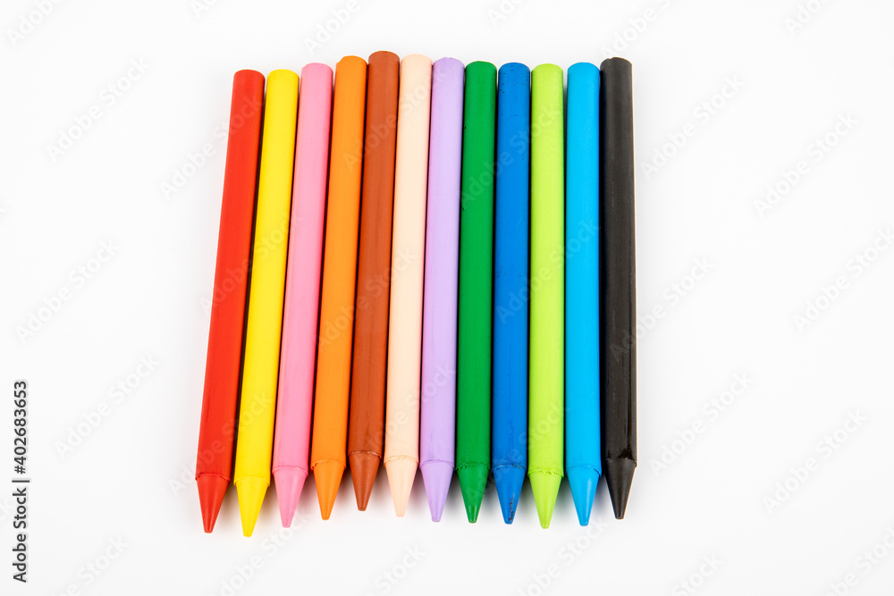 Colored wax crayons on a white background. Education and the creative process concept Colored wax crayons on a white background. Education and the creative process concept