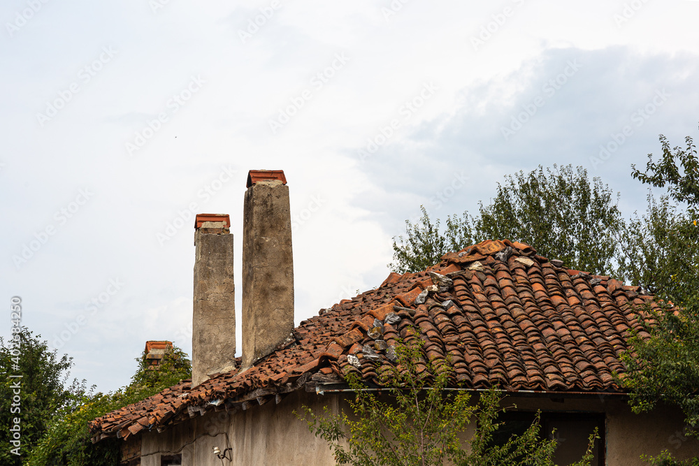 Chimneys of old wooden and stone house in a village Chimneys of old wooden and stone house in a village